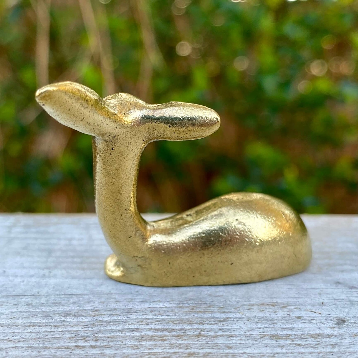 Solid brass deer sculpture by Wild Brass showcasing elegance and grace, with detailed antlers and a smooth, polished finish.
