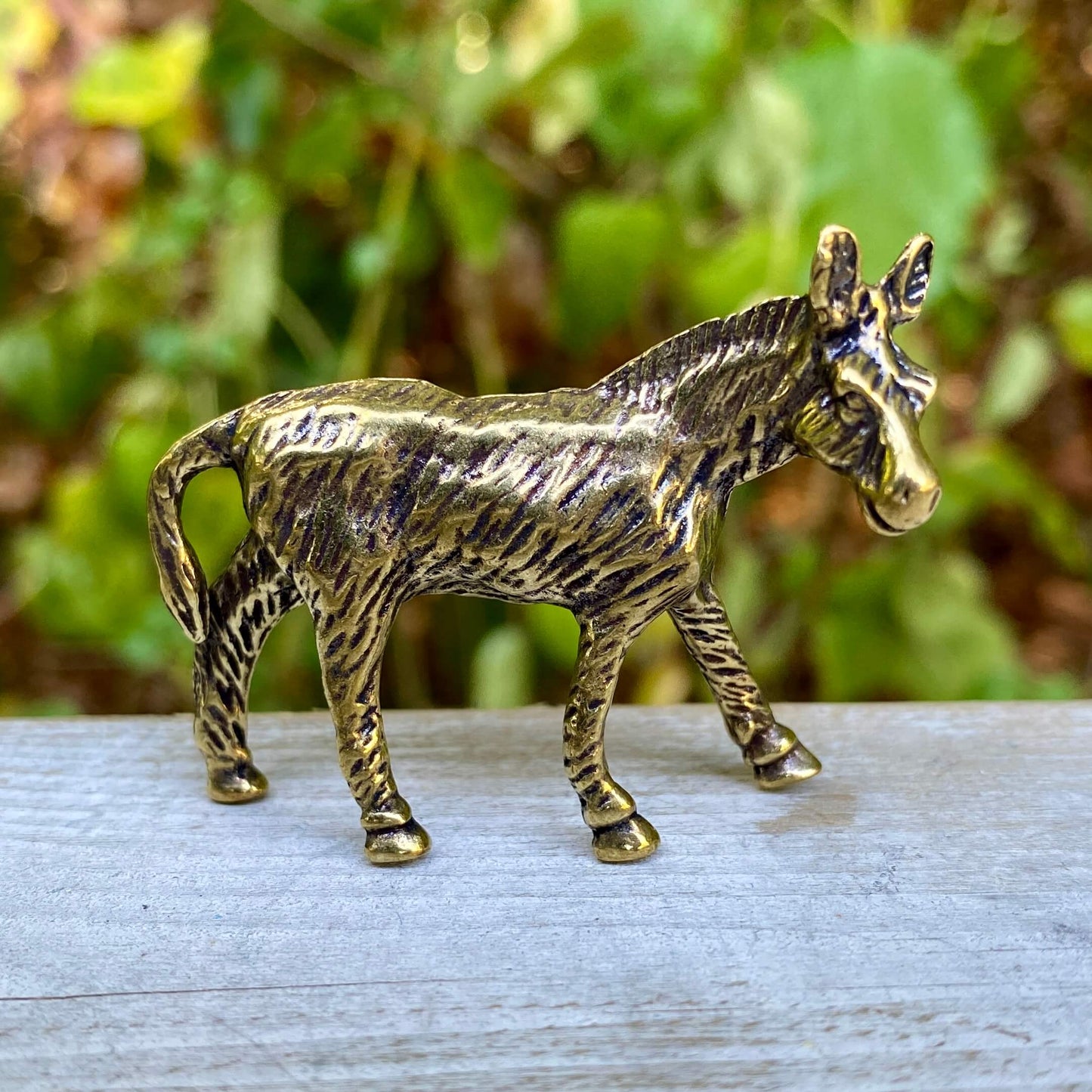 Solid brass donkey figurine by Wild Brass, symbolizing perseverance and humility, displayed on a neutral background.