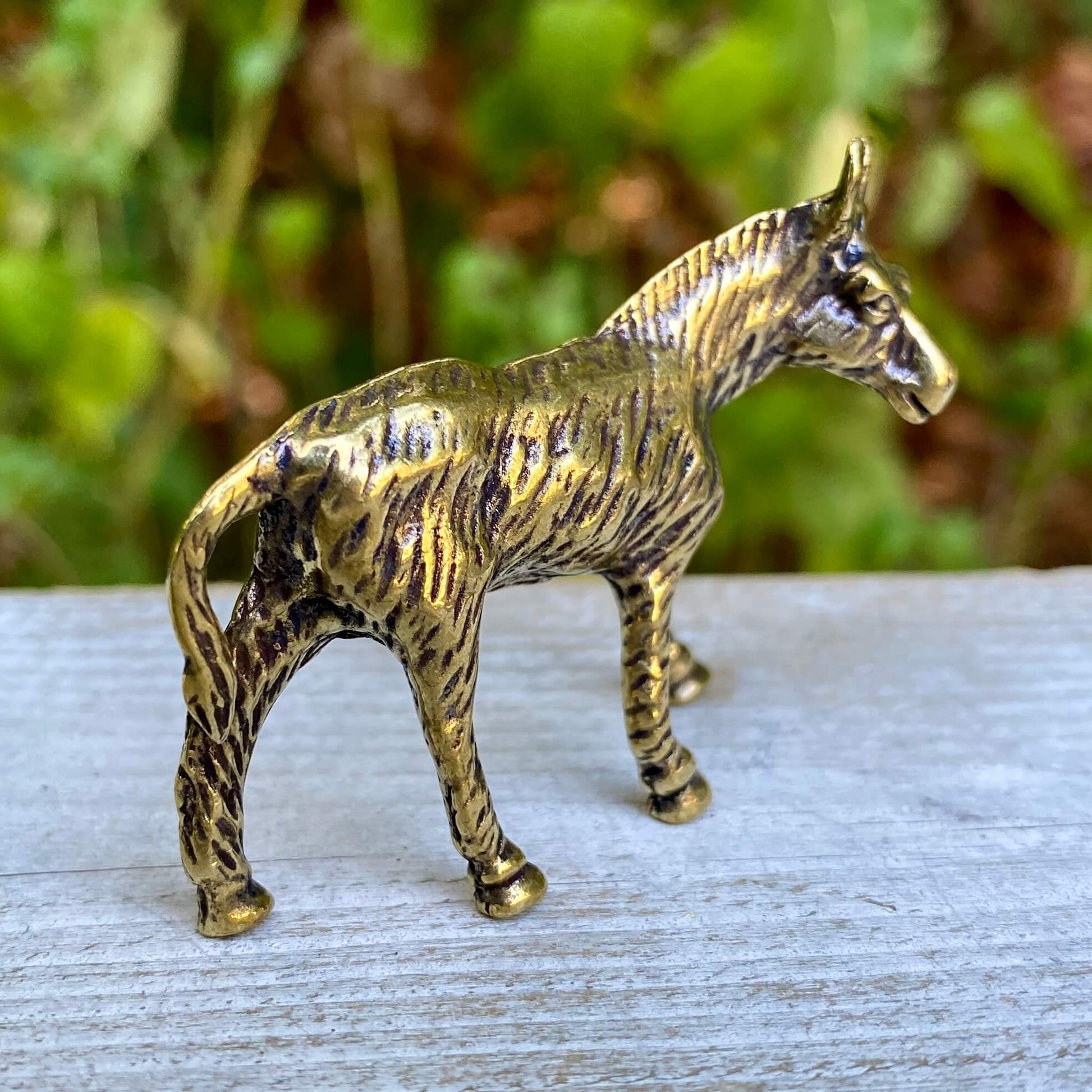 Solid brass donkey figurine by Wild Brass, symbol of perseverance and humility, detailed craftsmanship visible in the image.